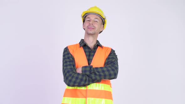 Studio Shot of Happy Man Construction Worker Smiling with Arms Crossed