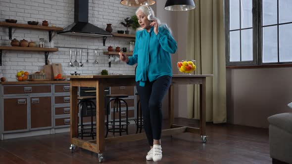 Cheerful Old Woman Dancing and Singing at Home