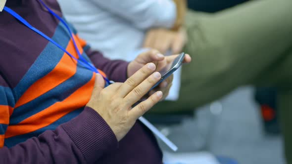 Closeup View of Young Male Student is Using Smartphone During Lecture at University Irrl