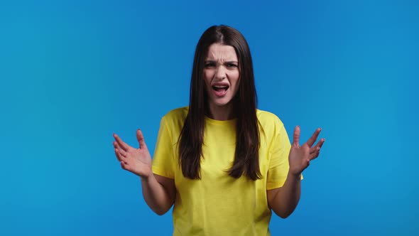 Furious Temperamental Woman on Blue Background