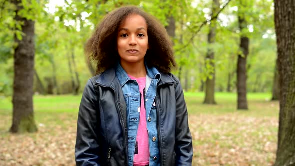 Young African Generous Girl with Fluffy Afro Hair Shows with Arms Gesture Come Here