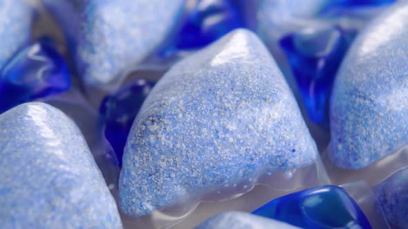 Powder and liquid blue detergent pods for dish washing machine. Macro