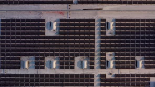 Aerial shot of solar panels covers the roof of a large building