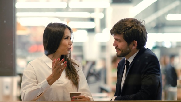 Business partners cheerful man and woman are talking in