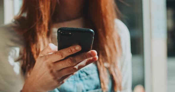 Close up portrait of girl browsing on mobile phone