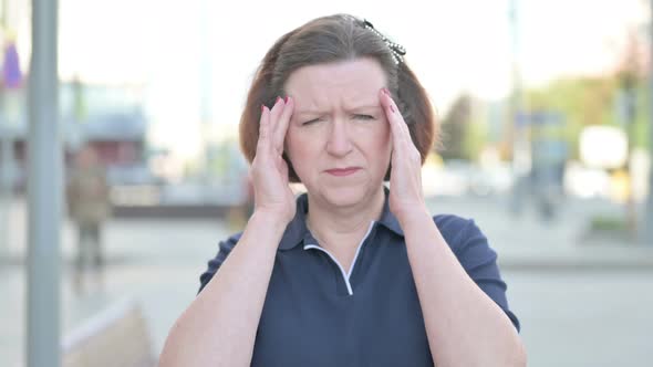 Portrait of Tense Old Woman with Headache Outdoor