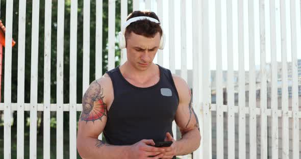 Portrait of Male Athlete Doing Exercises Outdoors in Summer