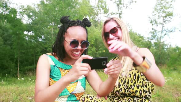 Two young women having a great time taking selfies