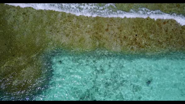 Aerial flying over seascape of marine lagoon beach holiday by blue lagoon with white sandy backgroun