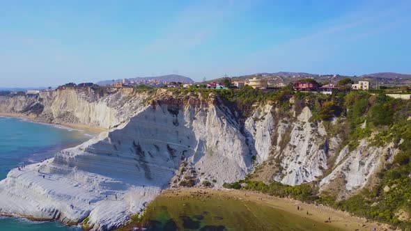 Arial shot of the Sicilian  White Cliffs of Scala dei Turchi rising up from the golden sandy beach b