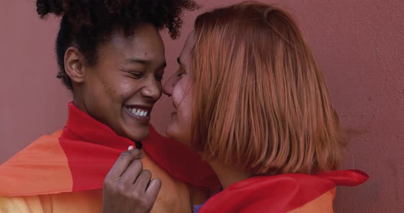 Multiracial lesbian couple having tender moment together - LGBT pride concept