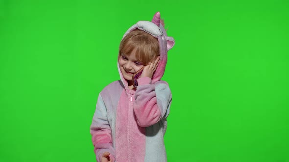 Little Kid Girl Daughter in Unicorn Pajamas Using Speaking Talking on Mobile Cell Phone with Mother