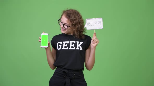 Young Happy Beautiful Nerd Woman Showing Phone with Selfie Paper Sign