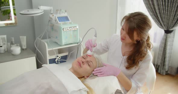Woman Receives A Hardware Phonophoresis Procedure From A Cosmetologist In A Spa Salon