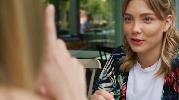 Slow motion shot of women talking outside coffee shop