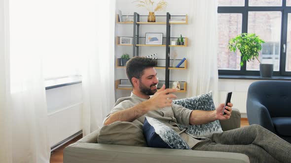 Man with Smartphone Having Video Call at Home