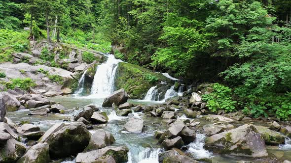 Mountain River Waterfall Flowing Between Rocky Shores in Carpathians Mountains Ukraine