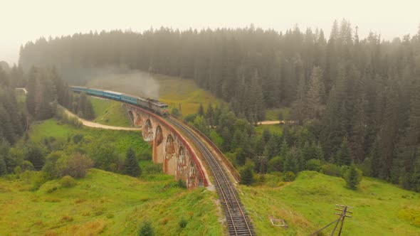 Train on the Railway Bridge in the Carpathian Mountains