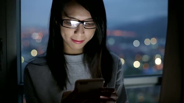 Woman use of mobile phone at night