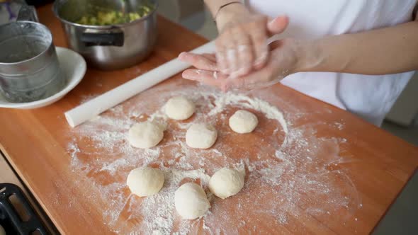 Female Hands Shape the Dough Into a Cake