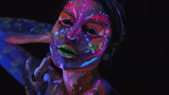 Closeup of a Girl's Face with an Ultraviolet Pattern in Neon Light