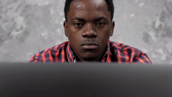 Close Up Face African American Businessman Works Laptop Chatting with Employees