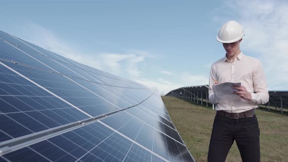 A Man Is Checking the Solar Power Panel at the Plant