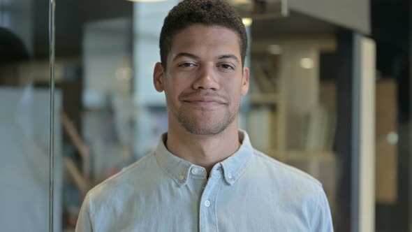 Young African Man Saying Yes with Head Gesture