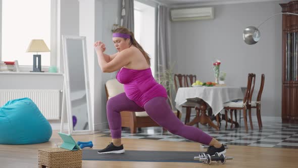 Side View of Obese Woman Trying to Do Twine Working Out Training at Home