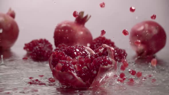 Falling Splitted Pomegranate Into the Water . Slow Motion