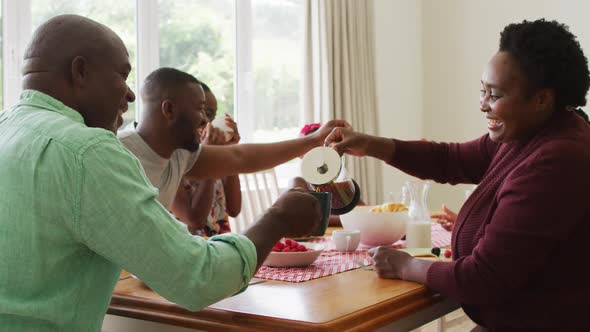 Three generation african american family having breakfast together at home