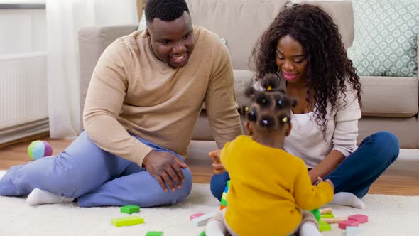 African Family Playing with Baby Daughter at Home