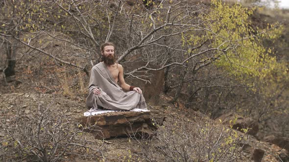 Yogi Meditating at Mountains in Autumn