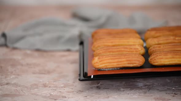 Freshly Baked Eclairs on a Baking Sheet