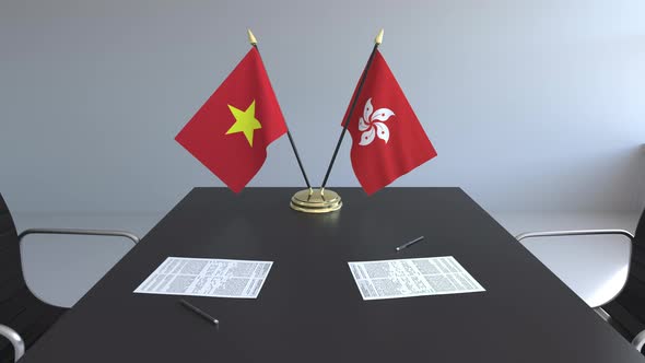 Flags of Vietnam and Hong Kong and Papers on the Table alt