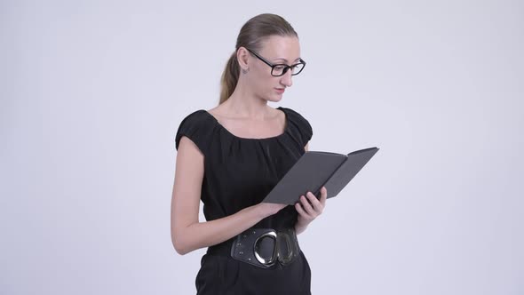 Shy Blonde Businesswoman Covering Face with Book