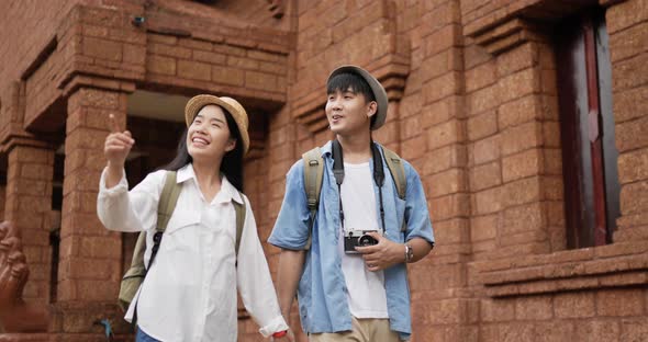 Couple hand together while visiting at ancient temple