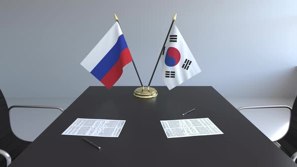 Flags of Russia and South Korea on the Table alt