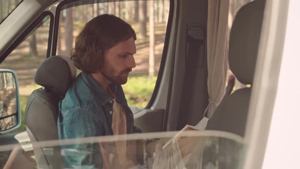 Man Reading Book in Trailer