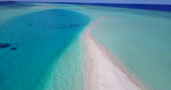 Wide fly over travel shot of a paradise sunny white sand beach and aqua turquoise water background i