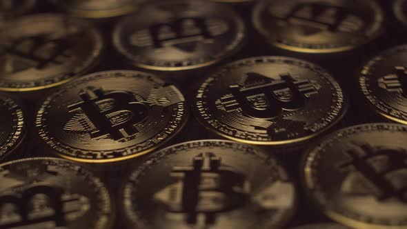 Golden Bitcoin Coins Closeup Lie on a Solid Background