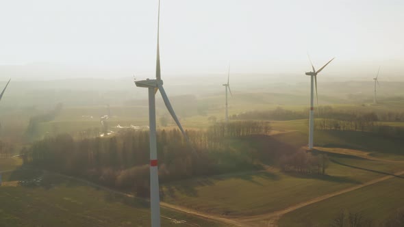 Panoramic View of a Farm with Wind Turbine at Sunset