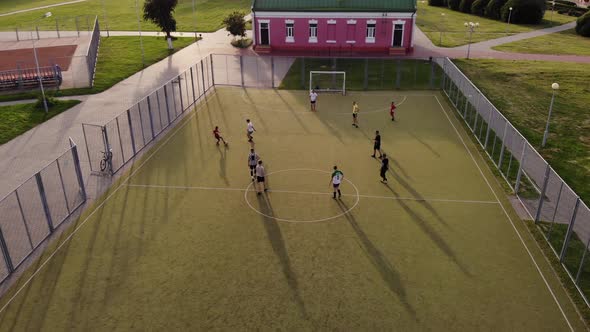 Young Men Play Amateur Soccer on the City Sports Ground. Shooting From a Copter. The Camera Is