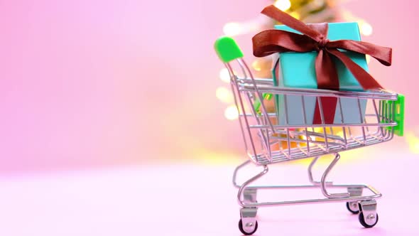 Present Box with a Ribbon in a Shopping Trolley Cart