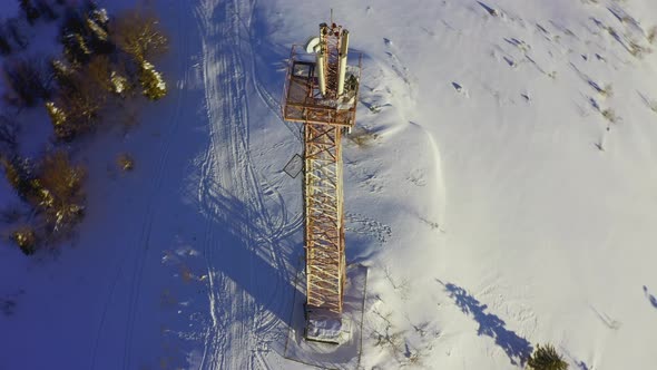 Flying Over Radio Communications Tower Mountain Snow Covered Winter Landscape