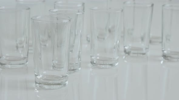 Many spirits or liquor drink glasses slow tilt 4K 2160p 30fps UltraHD footage - Close-up of  shot gl