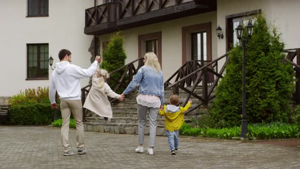 Happy Couple with Kids Walking Together