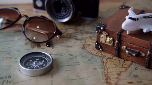 Toy plane and suitcase on vintage map