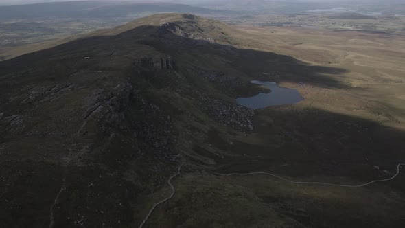 Hills And Mountain Slopes With A Small Lake In Cuilcagh Boardwalk Trail, Northern Ireland. Aerial Dr