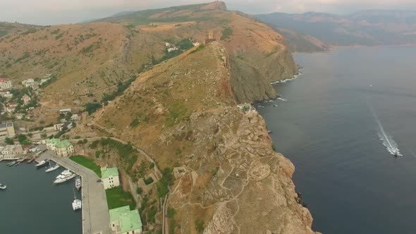 Drone View of Steep Cliffs and the Remains of a Ruined Fortress